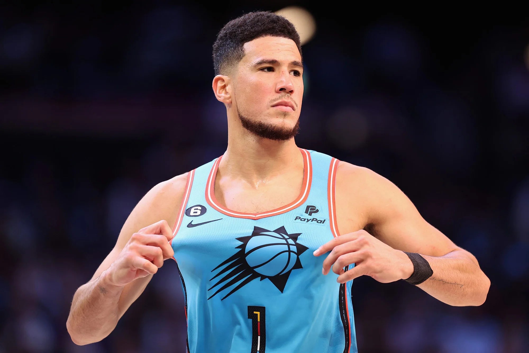 Devin Booker wearing a blue shirt.