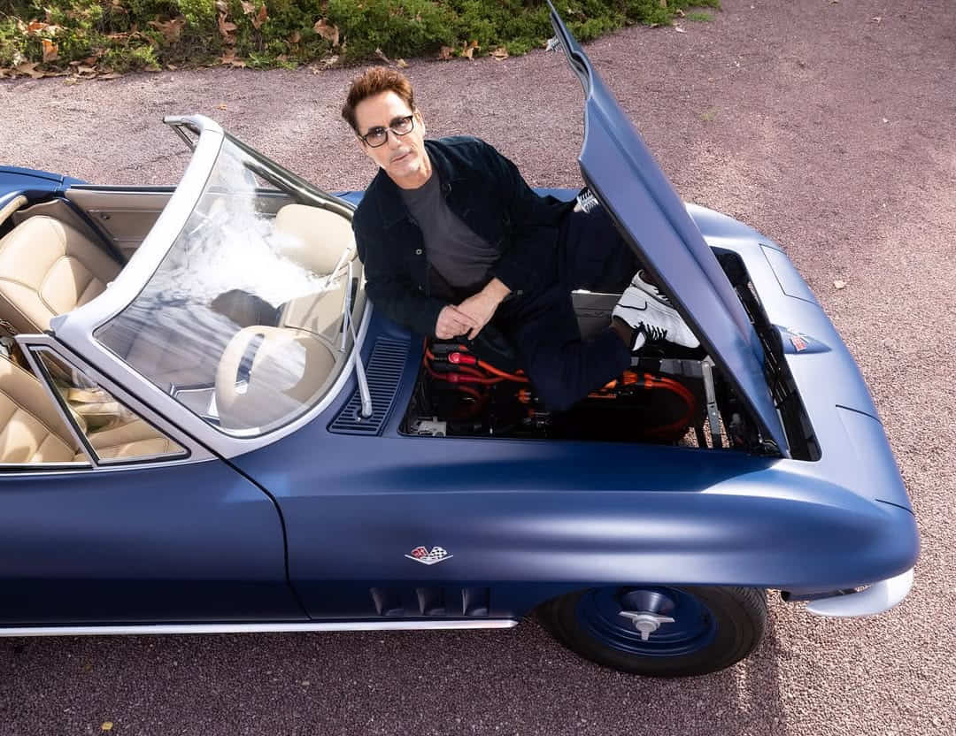 A top-angle shot of Robert Downey Jr. sitting in a blue car.