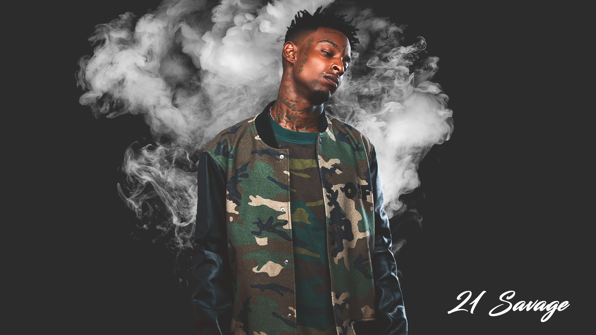 21 Savage wearing a camouflage outfit looking down with smoke in the background.