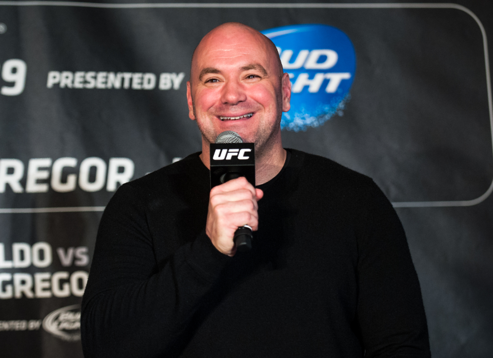 Dana White holding a microphone and addressing the audience at WFC