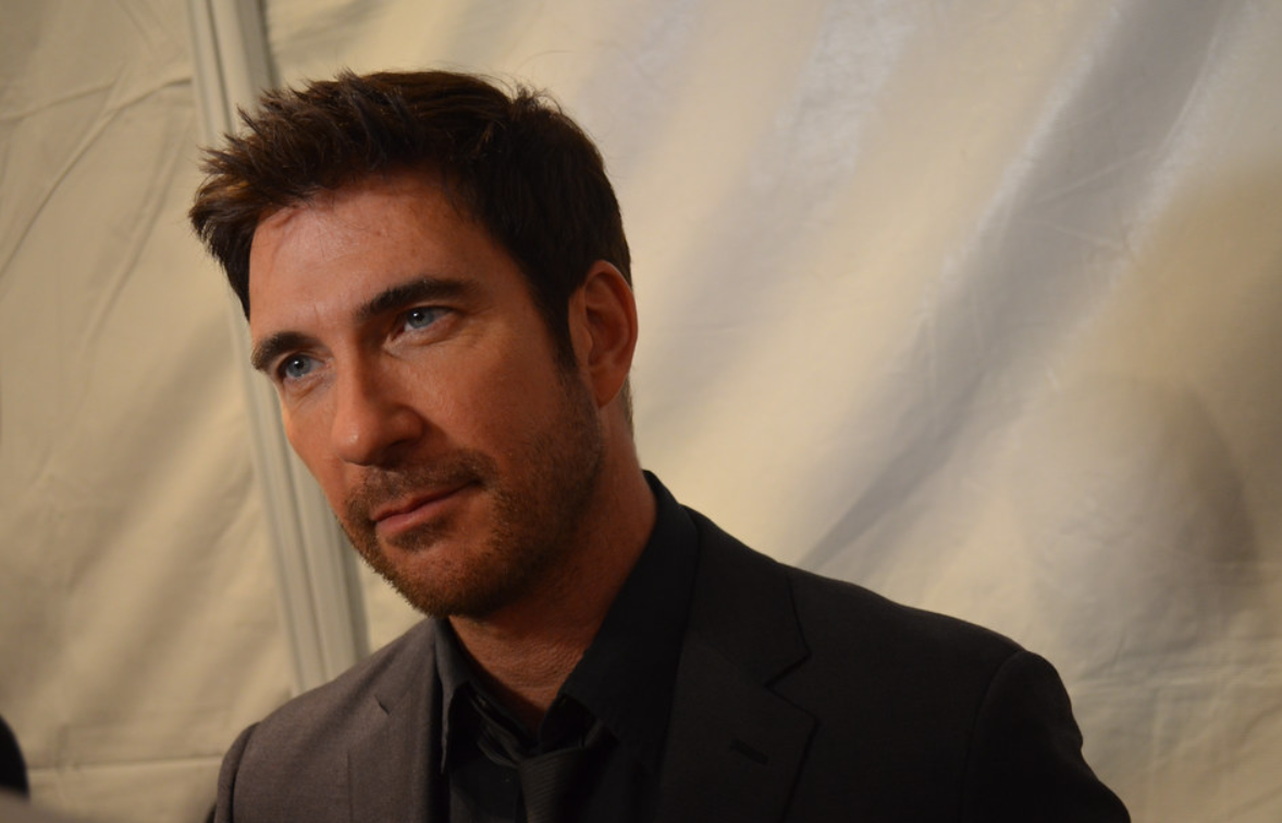 Dylan Mcdermott wearing a suit looking at the interviewer in an event