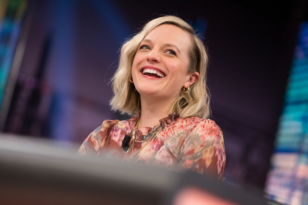 Elisabeth Moss with a happy expression on her face.