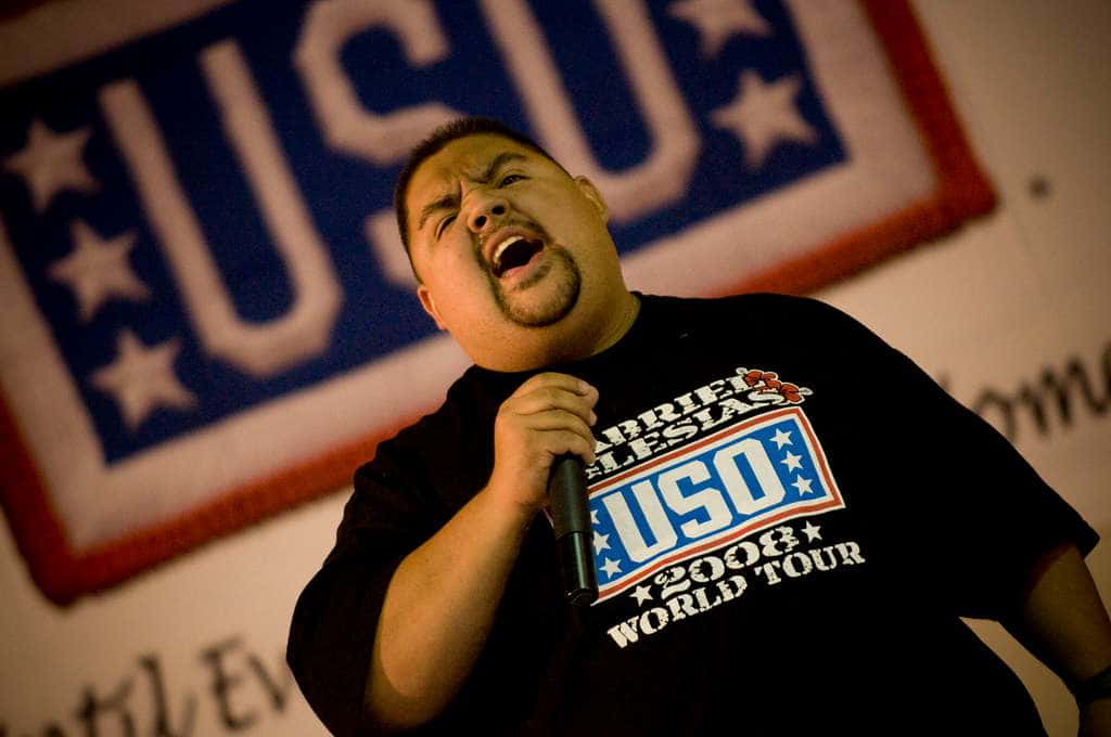 Gabriel lglesias holding a mic and addressing the crowd