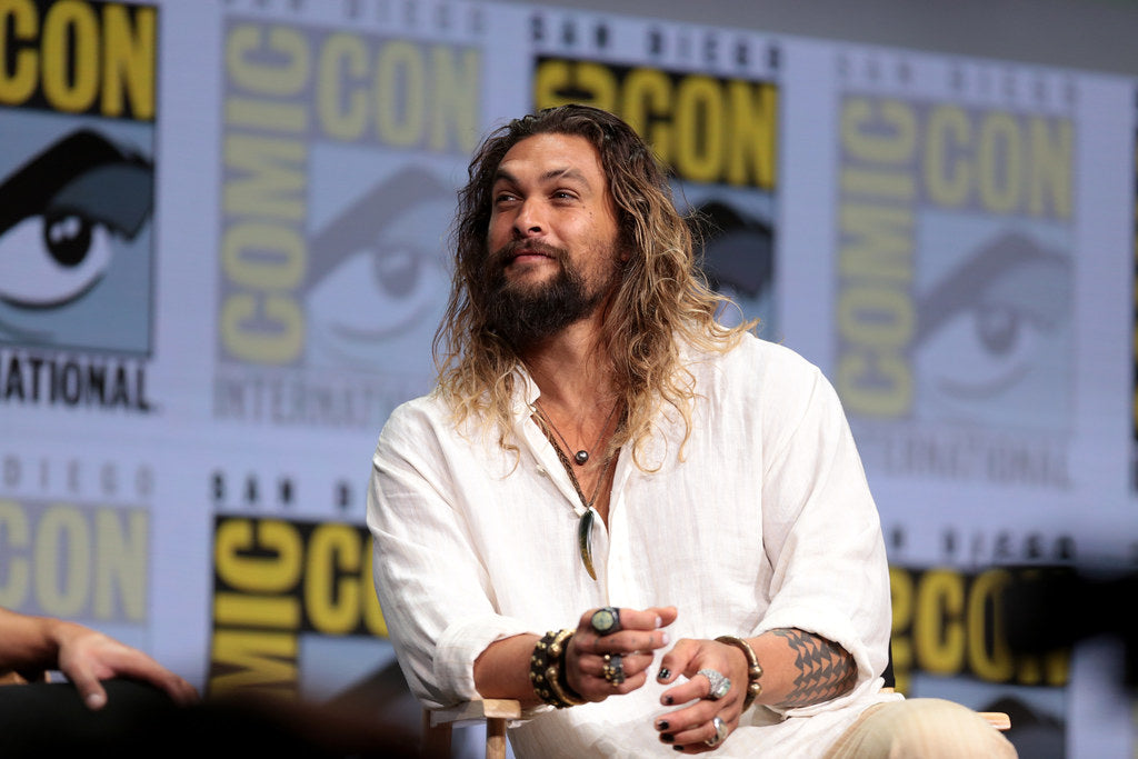  Jason Momoa in wearing a white shirt attending a comicon