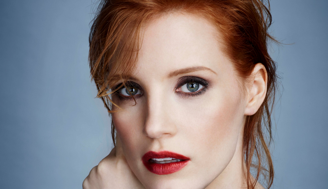 Jessica Chastain posing against a grey background.