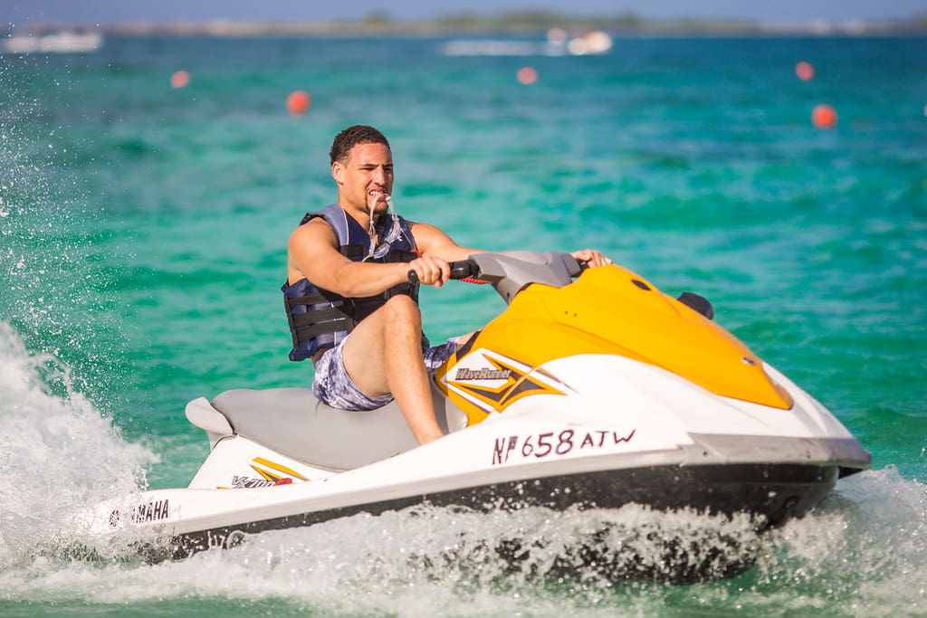 Klay Thompson riding a motorboat