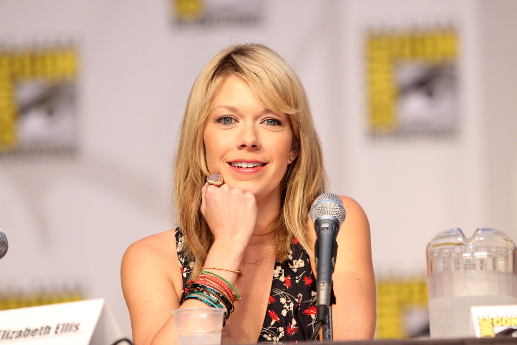 Mary Elizabeth Ellis is sitting at a table with a microphone in front of her. She is at a comicon.