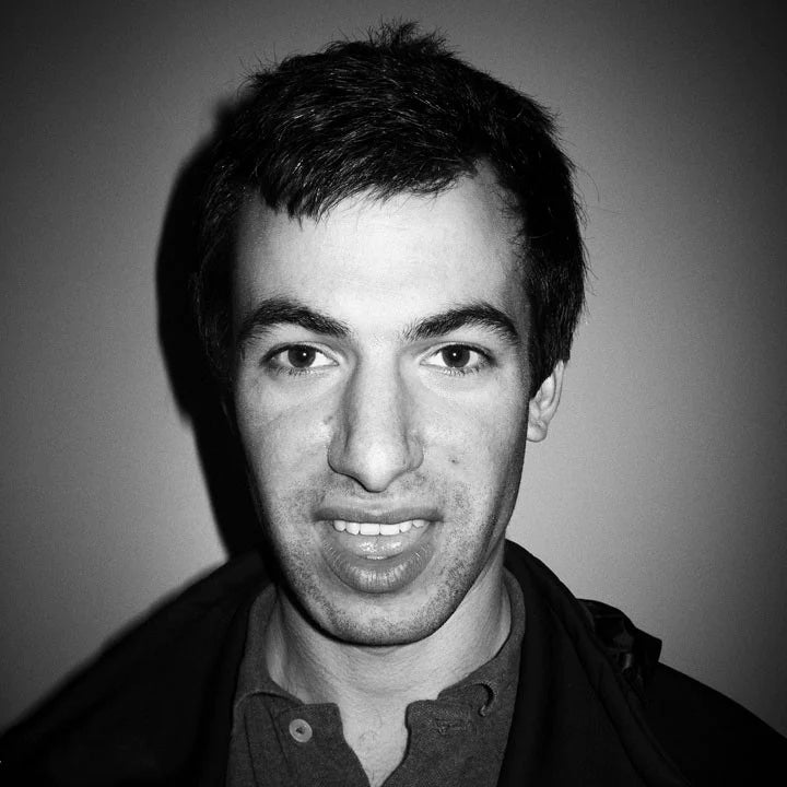 Nathan Fielder is staring into the camera in a black and white photo