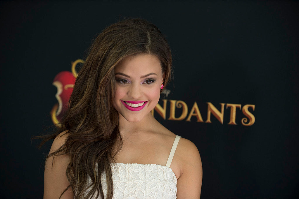 Sarah Jeffery in a white dress at the promotion of her film Descendants