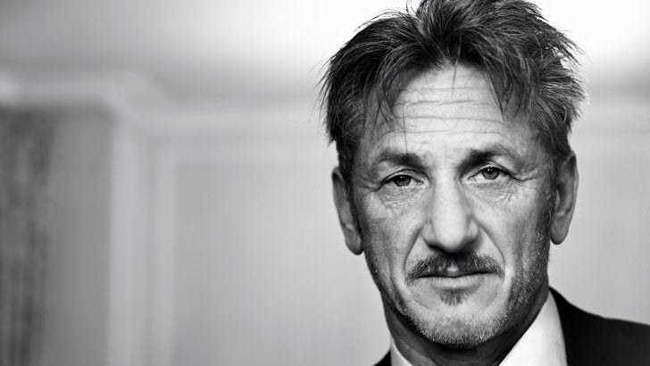 Black and white close up of Sean Penn, wearing a tuxedo and looking straight into the camera.