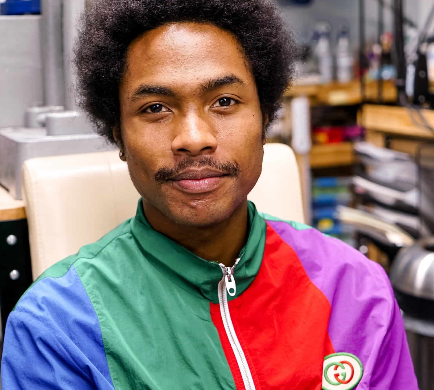 Steve Lacy, wearing a colorful jacket and smiling