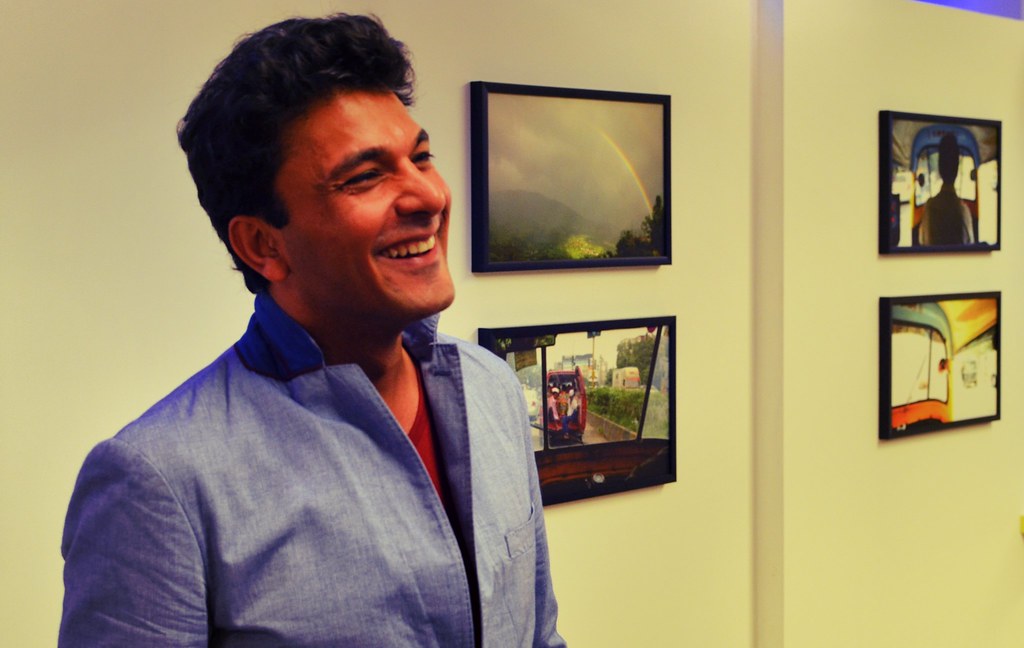 Vikas Khanna at an art museum, wearing a blue shirt and smiling 