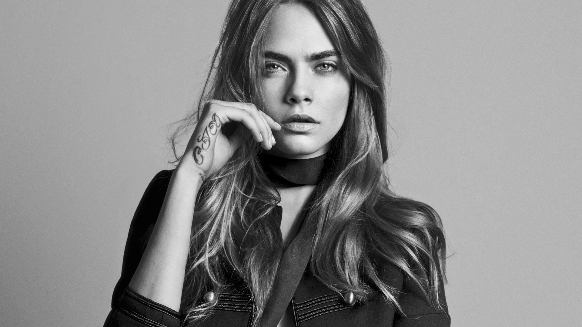 A black and white photograph of Cara Delevingne