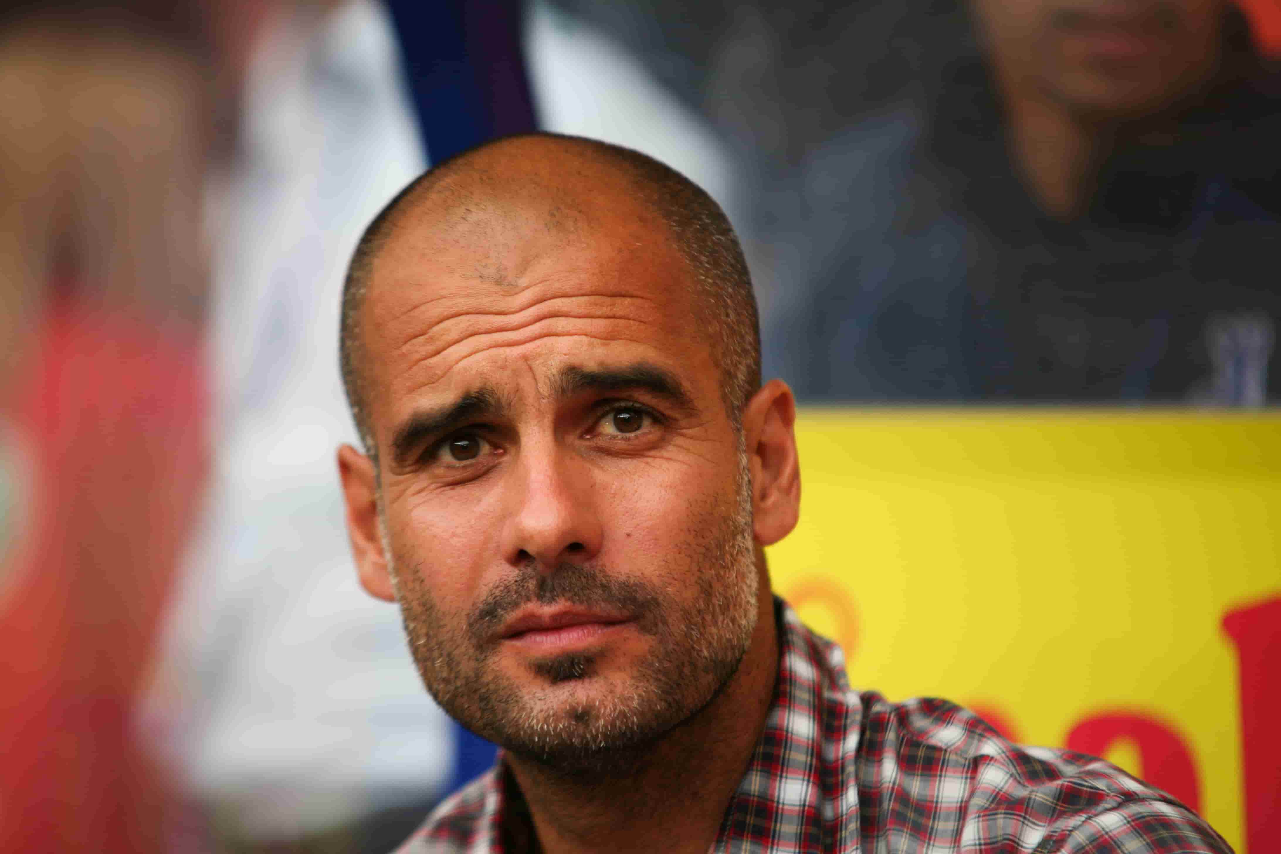 Pep Guardiola in a red and white check shirt