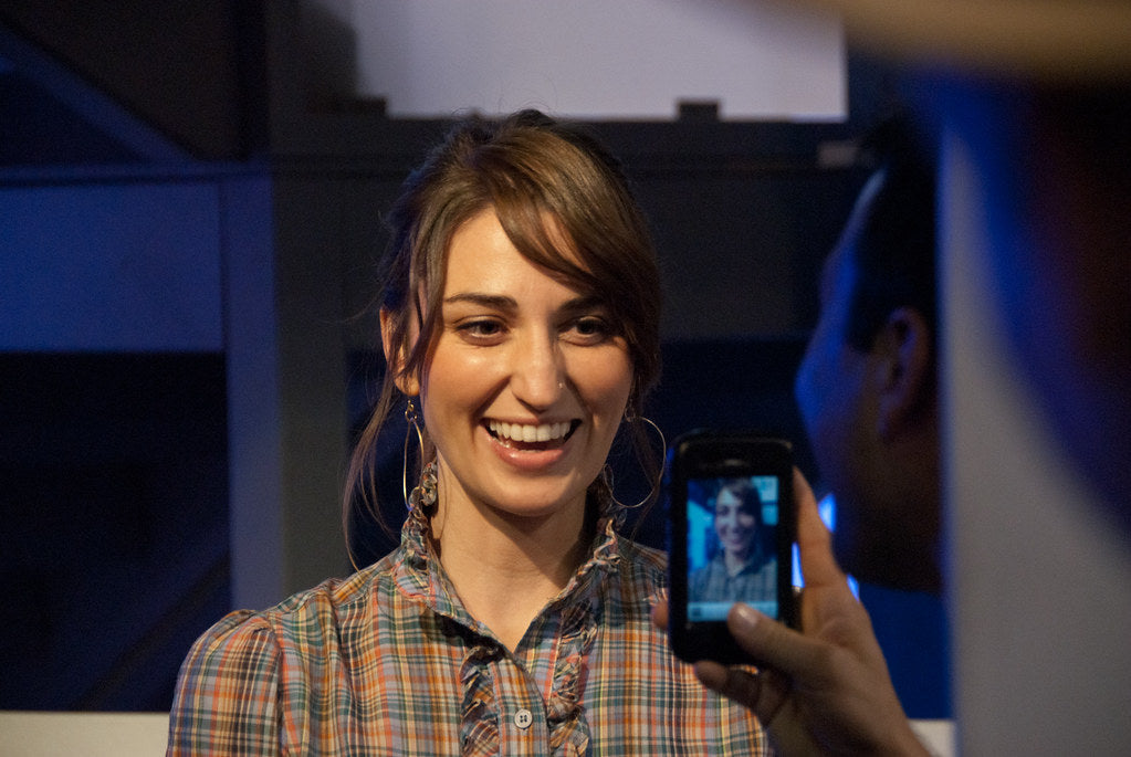 Sara Bareilles is smiling while getting clicked